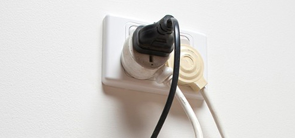 large amount of devices plugged into single power strip